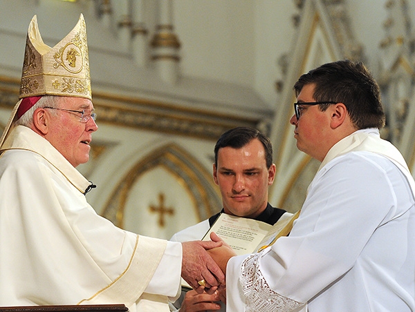 Bishop Richard J. Malone blesses Father Paul Stanislaw Cygan during a Mass at St. Joseph Cathedral where Cygan and three other men were ordained into the priesthood. (Dan Cappellazzo/Staff Photographer)